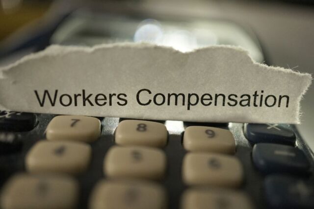 A calculator is used to calculate workers' comp.