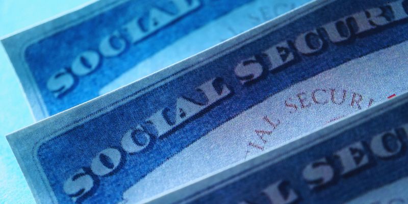 ssi-travel-restrictions1 Macro view of official Social Security cards stacked together with 'SOCIAL SECURITY' text visible, highlighting important rules and SSI travel restrictions that affect Supplemental Security Income recipients.