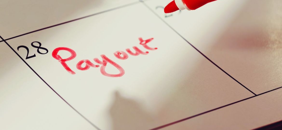 A calendar has notes on when a person will receive their workers' comp settlement payment.