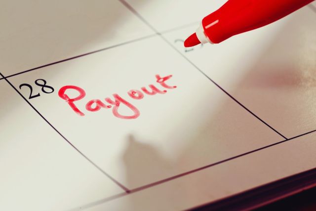 A calendar has notes on when a person will receive their workers' comp settlement payment.
